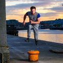 Jack is jumping over a boat anchor stump on the quays