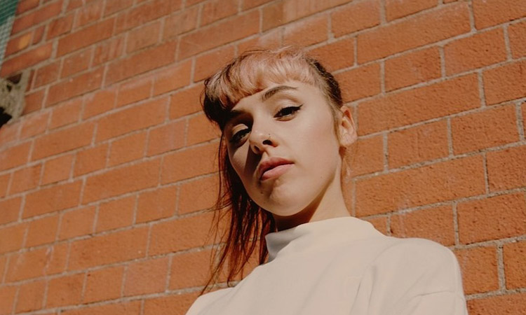 Gemma Dunleavy promo shot, looking down at the camera