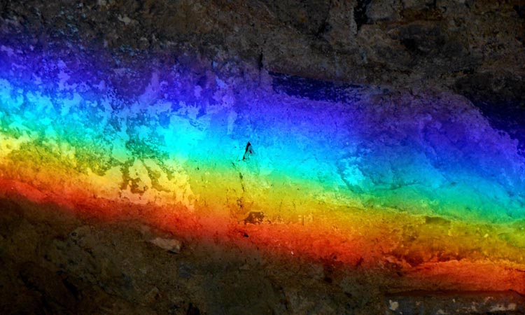 The Colours of the light spectrum on a dark background -International Day Against Homophobia, Transphobia and Biphobia